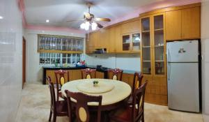 诗巫R&S Homestay Sibu - Wedding House with Large Parking Area and High Speed Unifi的厨房配有桌子和白色冰箱。