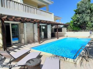 沃罗里尼Villa Larnaca Bay Resort的一座房子后院的游泳池