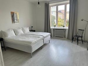 赫尔辛基Eteläinen Hesperiankatu的白色的卧室设有床和窗户