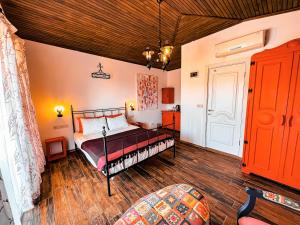 SokakagziAssos Longevity Hotel的铺有木地板的客房内设有一间卧室和一张床。