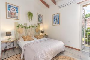莱特鲁瓦西莱Villa Mahana的白色卧室配有床和桌子