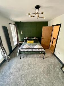 尼思THE SOUTH VALLEY HOME的一间卧室设有两张床和绿色的墙壁