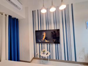 马尼拉Coast Residence Pasay的客厅的墙上配有电视