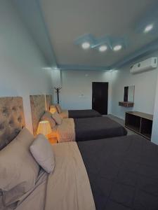 瓦迪穆萨Leen Guest House的一间卧室配有两张床和两盏灯。