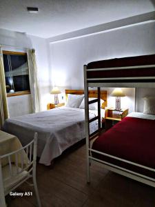 卡哈马卡Wayra Hospedaje的一间卧室设有两张双层床和一扇窗户。