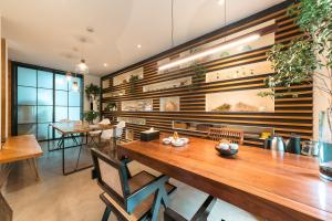 杭州梅开小筑客栈的一间带木桌和椅子的用餐室