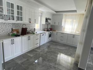 加济帕夏Villa Venus的白色的大厨房配有白色橱柜和大理石地板