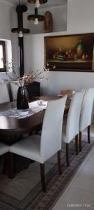 EleftheroúpolisMavridis House的一间带桌子和白色椅子的用餐室