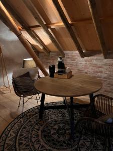 HolwierdeB&B Oldenbosch的砖墙房里的桌椅