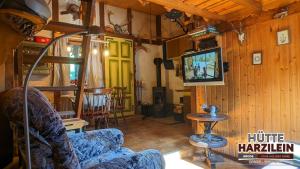 ZorgeArode Hütte Harzilein - Romantic tiny house on the edge of the forest的带沙发和电视的客厅