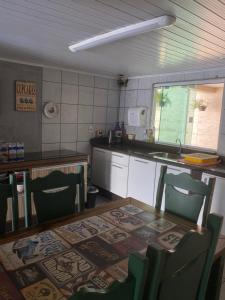布卢梅瑙Pousada Tia Moni的厨房配有桌椅和柜台。