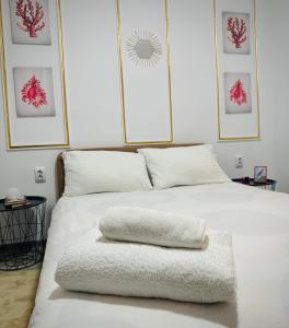 普洛耶什蒂Cazare Ploiesti的一张白色的床,上面有一条毛巾