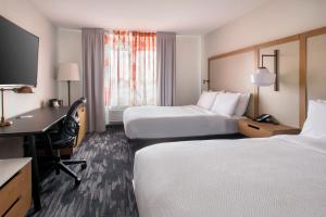 皇后区纽约拉瓜迪亚机场/芙拉世迎费尔菲尔德万豪酒店的酒店客房配有两张床和一张书桌