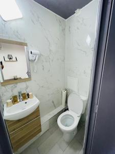 巴黎HOTEL LOUVAIN的白色的浴室设有卫生间和水槽。