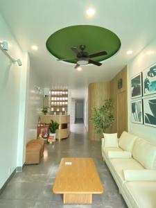 胡志明市Happy Hotel Bình Tân的带沙发和绿色天花板的客厅