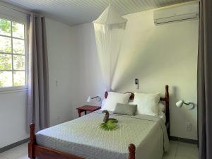 勒拉芒坦Casa Tropical · T3 Calme & Spacieux的一间卧室,床上有植物