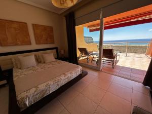 莫罗德哈布雷Terrazas de Jandía的一间卧室配有一张床,享有海景