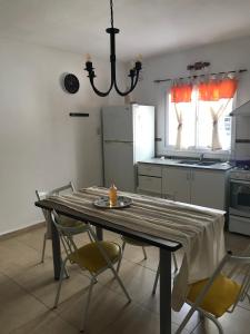 里奥塞瓦约斯Complejo Los Aromitos 1的厨房配有桌椅和吊灯。