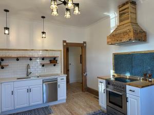 圣乔治The Cottage at 241 North的厨房配有白色橱柜和炉灶烤箱。