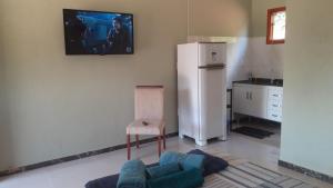 塞拉内格拉Chalé Bela Vista的厨房配有冰箱和椅子