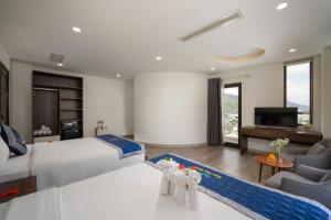 归仁Nam Thu Hotel的一间带大床的卧室和一间客厅