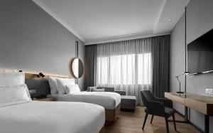 吉隆坡AC Hotel by Marriott Kuala Lumpur的酒店客房配有两张床和一张书桌