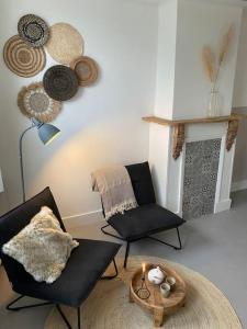 米德尔堡Slapen bij Zoet & Zilt的客厅配有两把椅子和壁炉