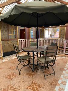 KimanaPenuel Plaza Hotel的庭院内桌椅和遮阳伞