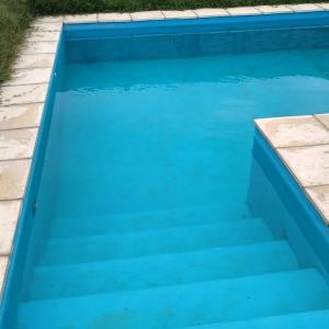 普洛缇尔Cabañas Plottier-Neuquén的庭院里带楼梯的蓝色游泳池