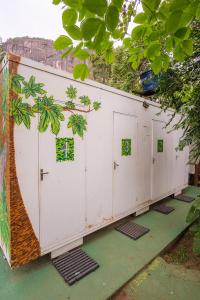 彼得罗波利斯Auá Hostel的一排带绿色窗户的白色车库门