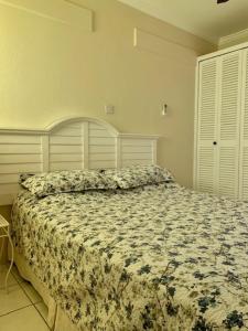 圣詹姆斯Kenridge Residences的一间卧室配有一张带花卉棉被的床
