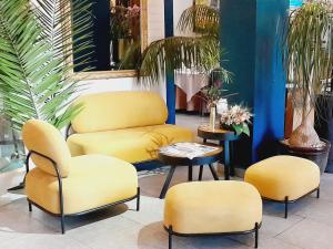 塔那那利佛维兰格酒店的房间里的一张桌子和四把黄色椅子
