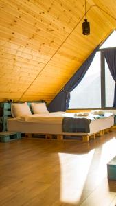 卡兹贝吉Cliffside cottage Kazbegi的木天花板的客房内的一张床位