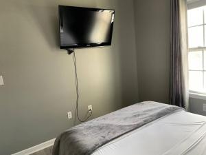 布卢明顿Luxury Townhome 2 Remodeled February 2021的卧室配有壁挂式平面电视。