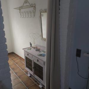 WittemOs Heem的浴室铺有瓷砖地板,配有带镜子的梳妆台。