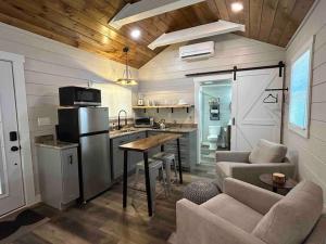 布赖森城Blissful Nook Tiny Home ~ Cozy Retreat w/ Hot Tub; near Town and Deep Creek的一间厨房和客厅,位于一个小房子里