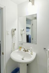 奥里利亚湖滨酒店的浴室设有白色水槽和镜子