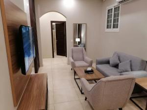 吉达Vital House Apartments شقق البيت الحيوي的客厅配有两张沙发和一台电视机
