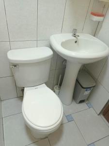 利马Female Accommodation Experience in front of Lima Airport的白色的浴室设有卫生间和水槽。