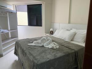 马塞约Apartamento á beira mar em Maceió的一间卧室配有带毛巾的床