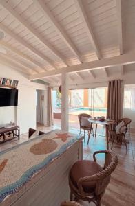 弗洛里亚诺波利斯Casa com piscina climatizada em frente à Praia do Santinho的卧室配有一张床和一张桌子及椅子