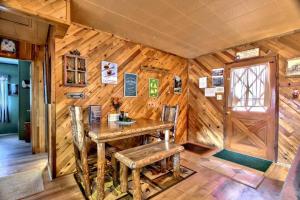 大熊湖Los Osos w/ Privarte Spa and BBQ的客房设有木墙、木桌和椅子。