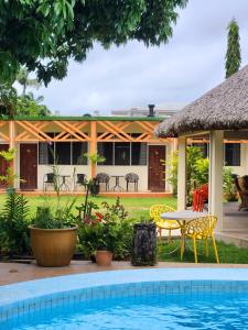 卢甘维尔Hotel Santo Vanuatu的一个带游泳池和桌椅的度假村
