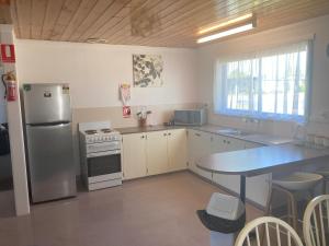 圣海伦斯凯琳度假公寓的厨房配有不锈钢冰箱和桌子