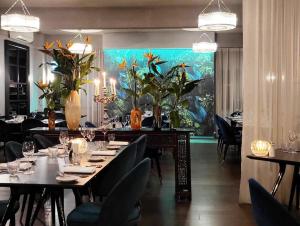 奥兰治The Oriana Orange - Retro Hotel & Resort的用餐室配有桌椅和鱼画