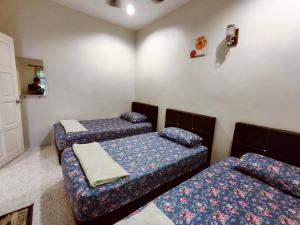 峇株巴辖TREX_Batu Pahat Homestay的一间房间,有三张床