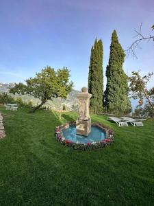 拉维罗Villa Barluzzi的公园内草原上的喷泉,设有两张野餐桌