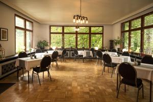 韦尼格罗德Hotel Mühlental的用餐室设有桌椅和窗户。