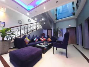 舍夫沙万贝尔肯布鲁公寓式酒店的客厅配有紫色沙发和桌子