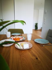 格拉茨Spacy Apartment next to the center of Graz with terrasse的上面有盘子的桌子